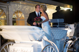 horse drawn carriage with bride and groom