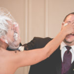 Bride and groom with cake in face