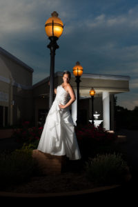 Bride standing on a lamp post